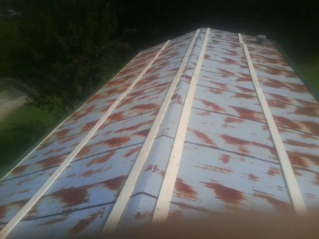 Rusted metal roof panels with new wood purlins before replacement — Storm Damage Roof Repair in Shannon by Roofing Brothers