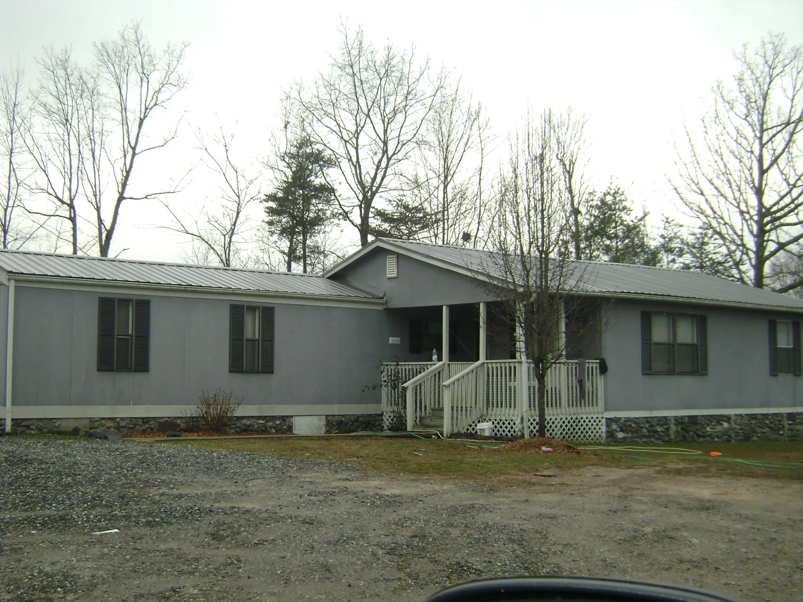Metal roof over a manufactured home with a covered front porch in Shannon